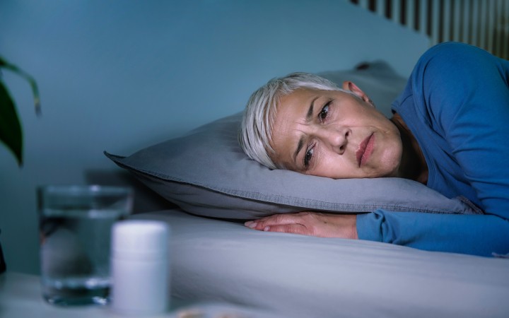 Insomnia and sleeping pills that do not work. Mature woman with sleeping problems awake in the middle of the night